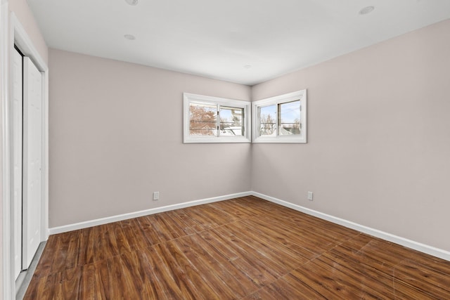 unfurnished bedroom with wood-type flooring and a closet