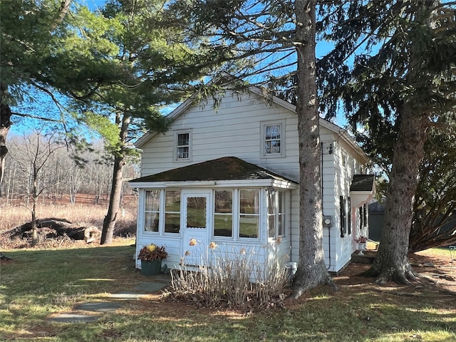 view of side of property with a lawn