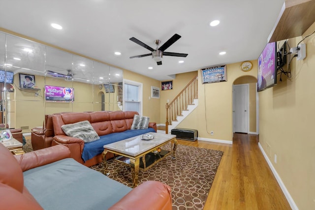 living room with hardwood / wood-style floors and ceiling fan