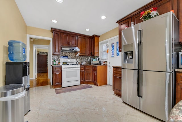 kitchen featuring decorative backsplash, stainless steel fridge with ice dispenser, and white range with gas stovetop