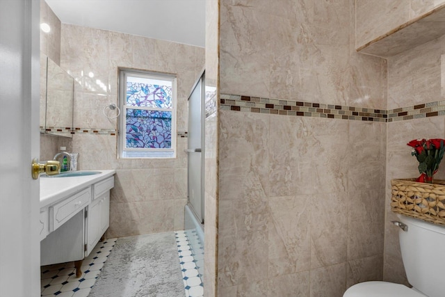 full bathroom featuring combined bath / shower with glass door, vanity, and toilet