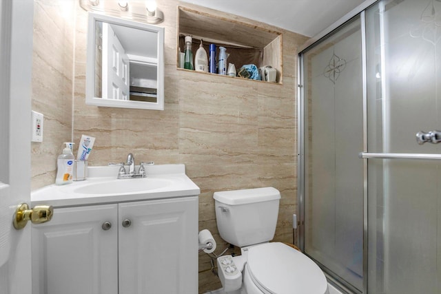 bathroom featuring walk in shower, vanity, and toilet