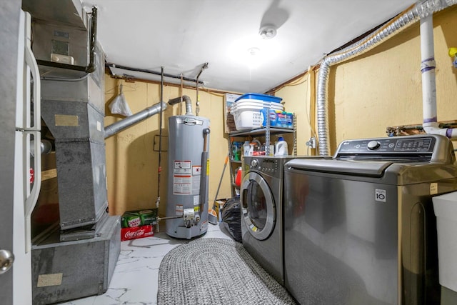 laundry area featuring gas water heater and washing machine and clothes dryer