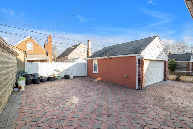 view of patio / terrace featuring an outbuilding and a garage