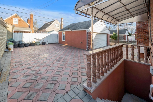 view of patio / terrace featuring a garage and an outdoor structure