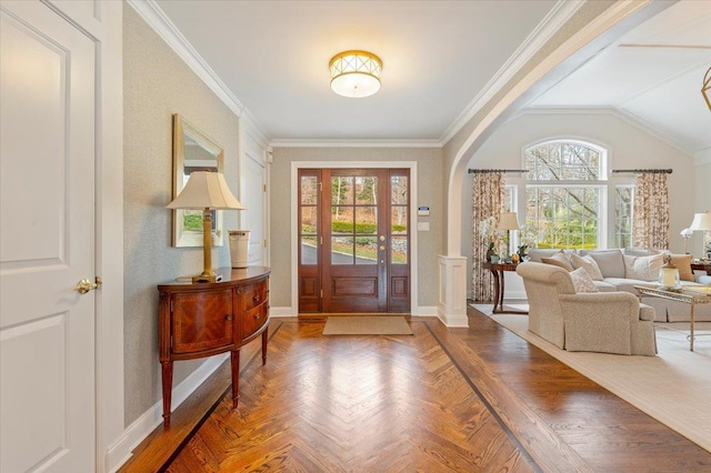 entrance foyer featuring ornamental molding, parquet floors, and vaulted ceiling