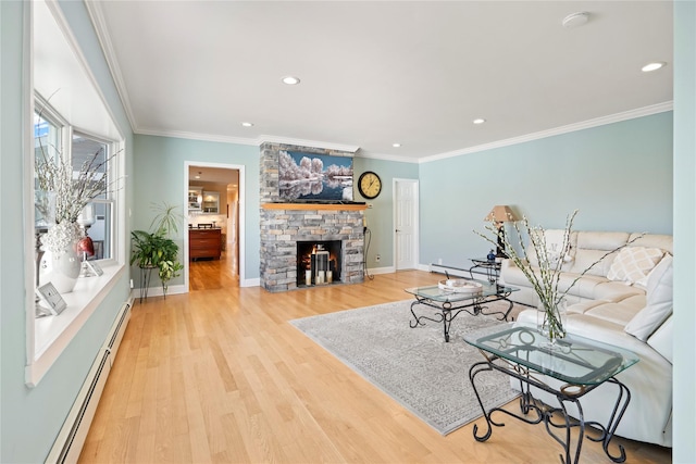 living room with ornamental molding, light hardwood / wood-style flooring, a stone fireplace, and a baseboard radiator