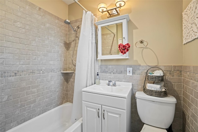 full bathroom with toilet, tile walls, vanity, and shower / bath combo with shower curtain