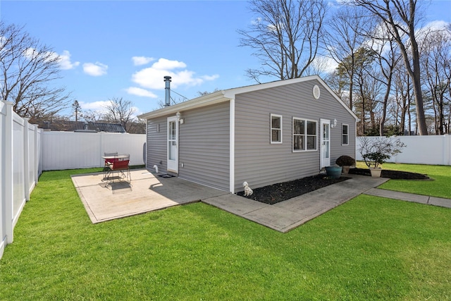 rear view of property featuring a patio area and a lawn