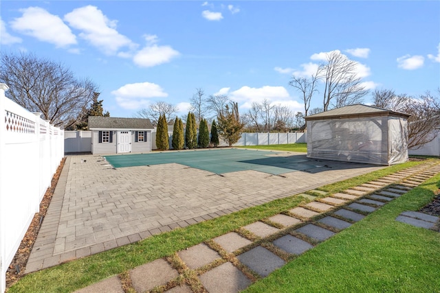 view of pool featuring a patio area and an outbuilding