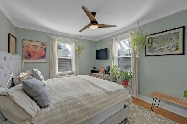 bedroom with crown molding, ceiling fan, and light hardwood / wood-style floors