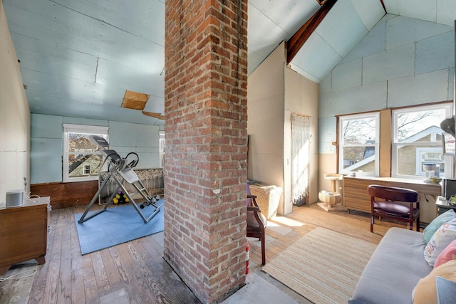 interior space featuring hardwood / wood-style floors and high vaulted ceiling