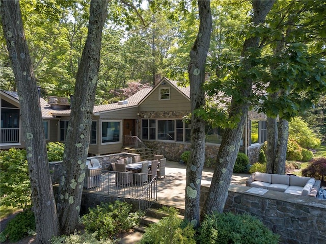 rear view of property with a patio and an outdoor hangout area