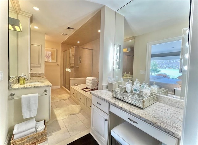 bathroom featuring tile patterned floors, vanity, and a shower with shower door