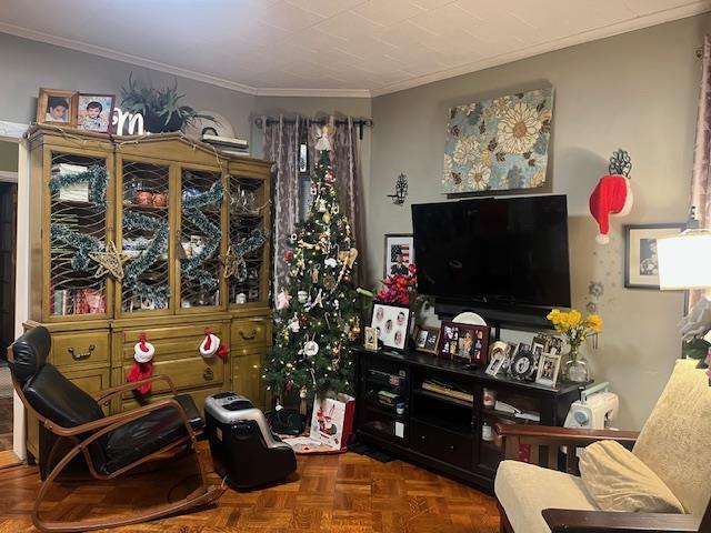 sitting room with parquet floors and crown molding