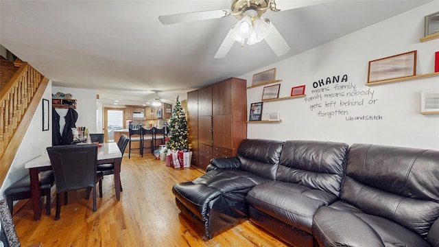 living room featuring light wood-type flooring and ceiling fan