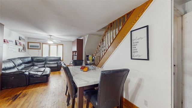 dining room featuring hardwood / wood-style flooring, ceiling fan, and a wall mounted air conditioner