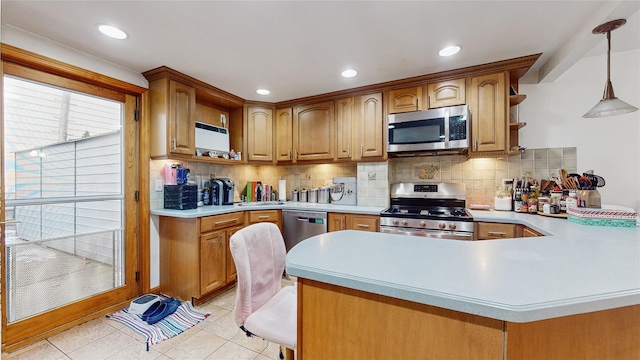 kitchen with kitchen peninsula, appliances with stainless steel finishes, backsplash, light tile patterned floors, and hanging light fixtures