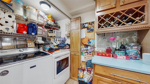 kitchen with washer and clothes dryer and light tile patterned floors