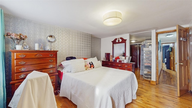 bedroom featuring a closet and light wood-type flooring