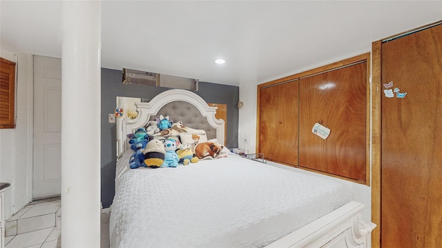 bedroom with a closet and light tile patterned floors