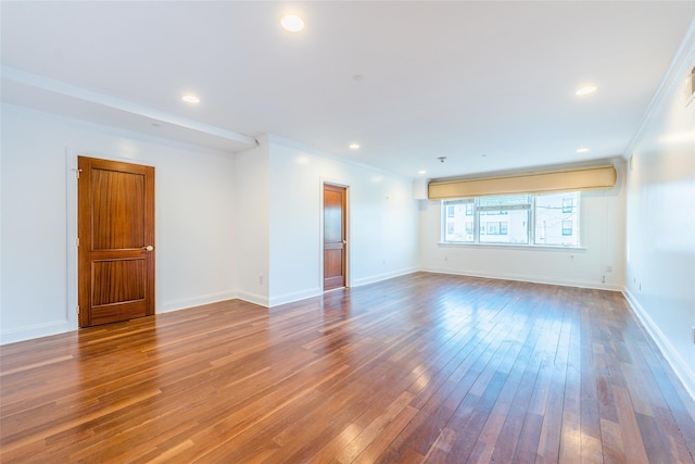 spare room with crown molding and hardwood / wood-style flooring