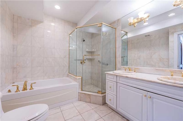 full bathroom featuring tile patterned floors, separate shower and tub, toilet, vanity, and tile walls