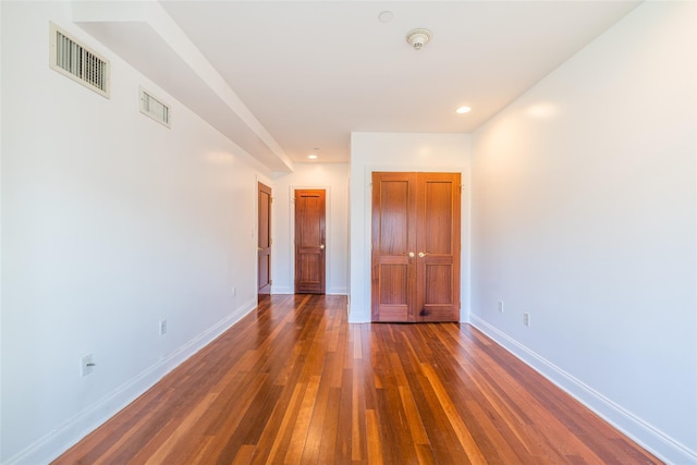 unfurnished room featuring dark wood-type flooring