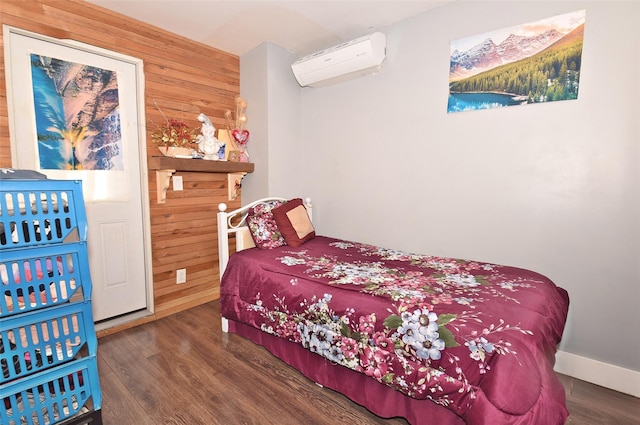 bedroom featuring dark hardwood / wood-style floors, an AC wall unit, and wooden walls