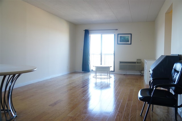 interior space featuring a wall mounted AC and light wood-type flooring