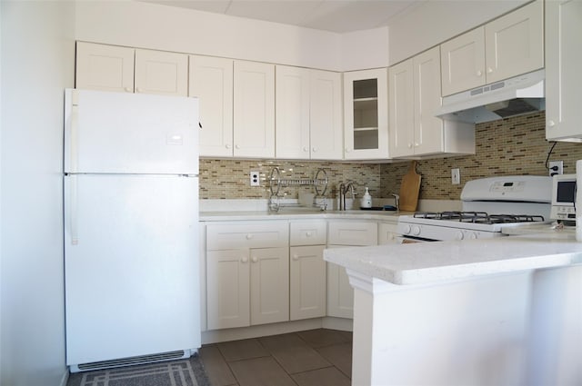 kitchen featuring tile patterned floors, decorative backsplash, white cabinets, and white appliances