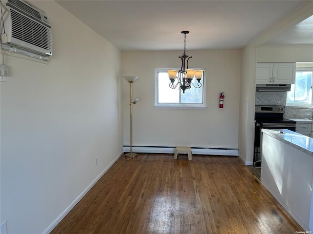 kitchen featuring white cabinetry, a wall mounted AC, a chandelier, decorative light fixtures, and decorative backsplash