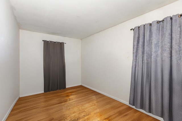 empty room with hardwood / wood-style flooring