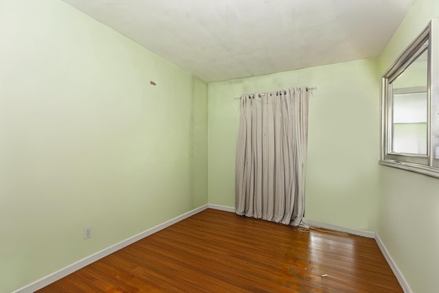 unfurnished room featuring dark hardwood / wood-style flooring