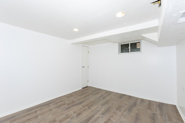 basement with hardwood / wood-style floors