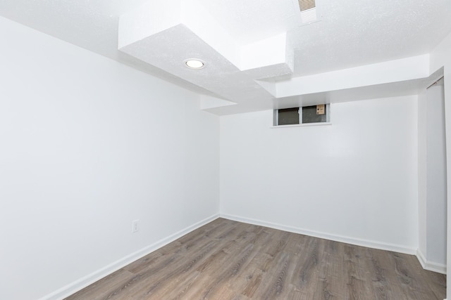 empty room featuring hardwood / wood-style flooring and a textured ceiling