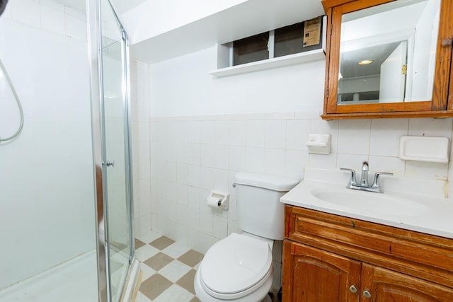 bathroom featuring tile walls, a shower with shower door, toilet, decorative backsplash, and vanity