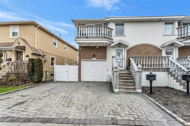 view of front of home featuring a balcony and a garage