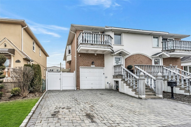 view of front facade featuring a balcony and a garage