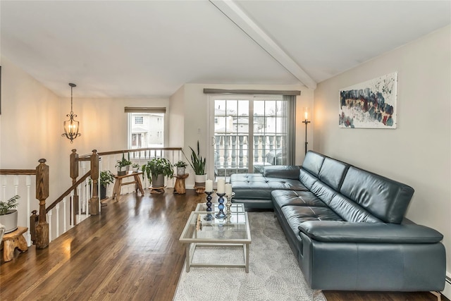 living room featuring vaulted ceiling with beams, baseboard heating, and dark wood-type flooring