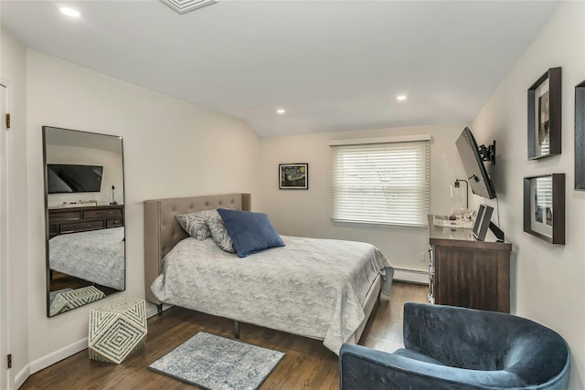 bedroom featuring dark wood-type flooring and a baseboard heating unit