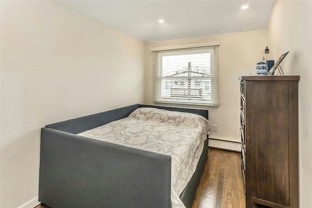 bedroom featuring dark hardwood / wood-style floors and a baseboard radiator