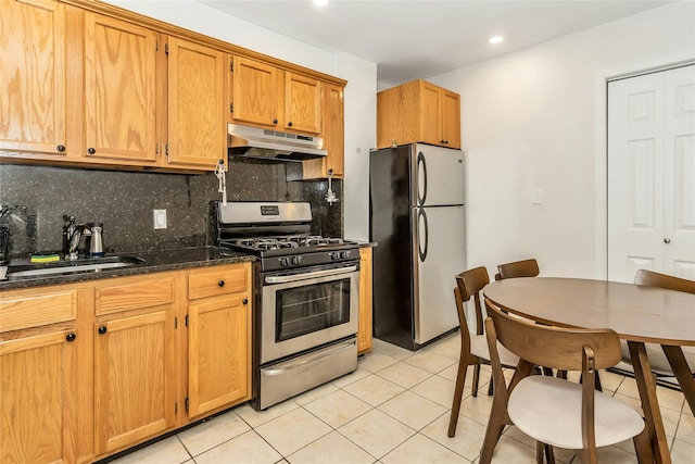 kitchen with backsplash, sink, light tile patterned flooring, and appliances with stainless steel finishes