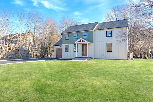 view of front of house with a front yard and a garage