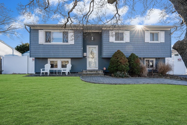 bi-level home with a front lawn