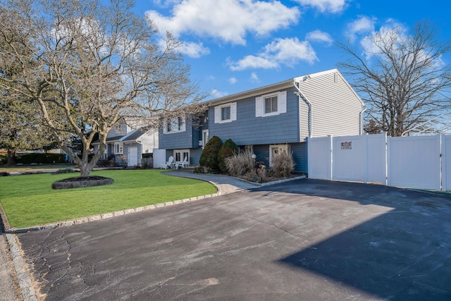 split foyer home with a front lawn