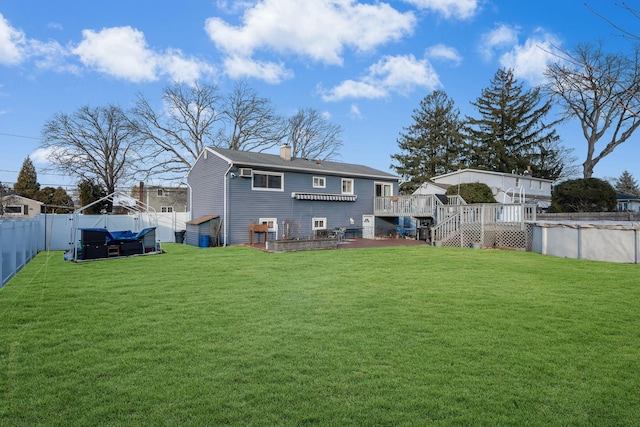 rear view of property with a pool side deck and a yard