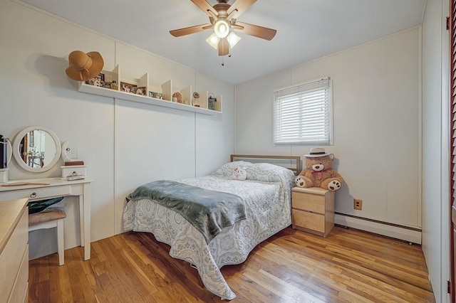 bedroom featuring ceiling fan, a baseboard heating unit, and light wood-type flooring