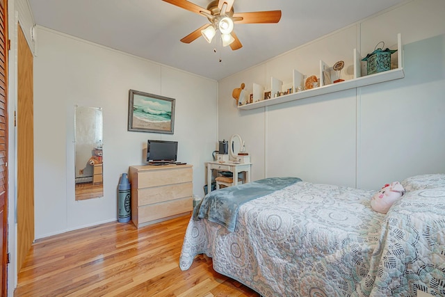 bedroom with ceiling fan and light hardwood / wood-style flooring