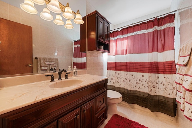 bathroom with tile walls, toilet, and vanity